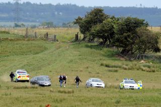 Gateshead shootings. Armed police are seen in a field in Rothbury, Northumberland, as they continue the search for Raoul Moat.