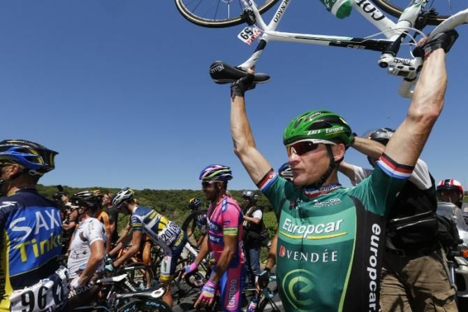 Thomas Voeckler (Europcar) holds his bike aloft as he tries to get around a crash blocking the road.