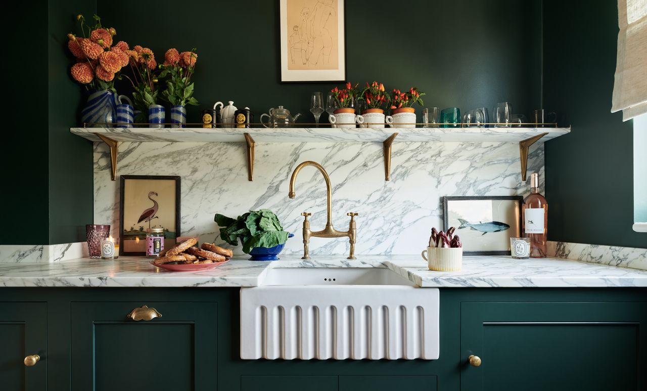 Green kitchen with marble splashback