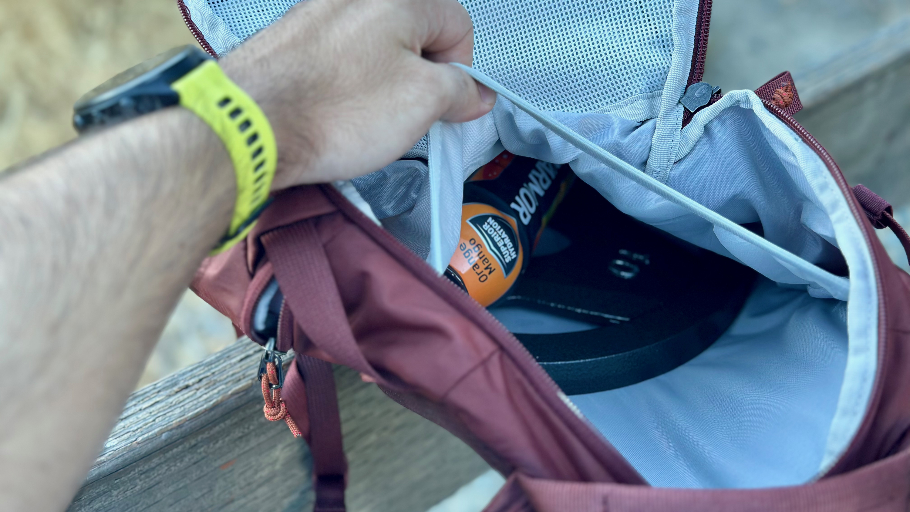 The writer opens his bag to reveal a weight training bowl with some food and drink.