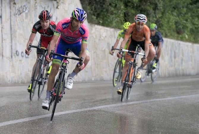 The riders take it carefully on a wet corner