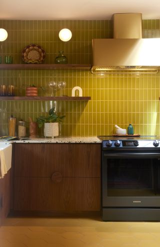 a wood kitchen with chartreuse backsplash