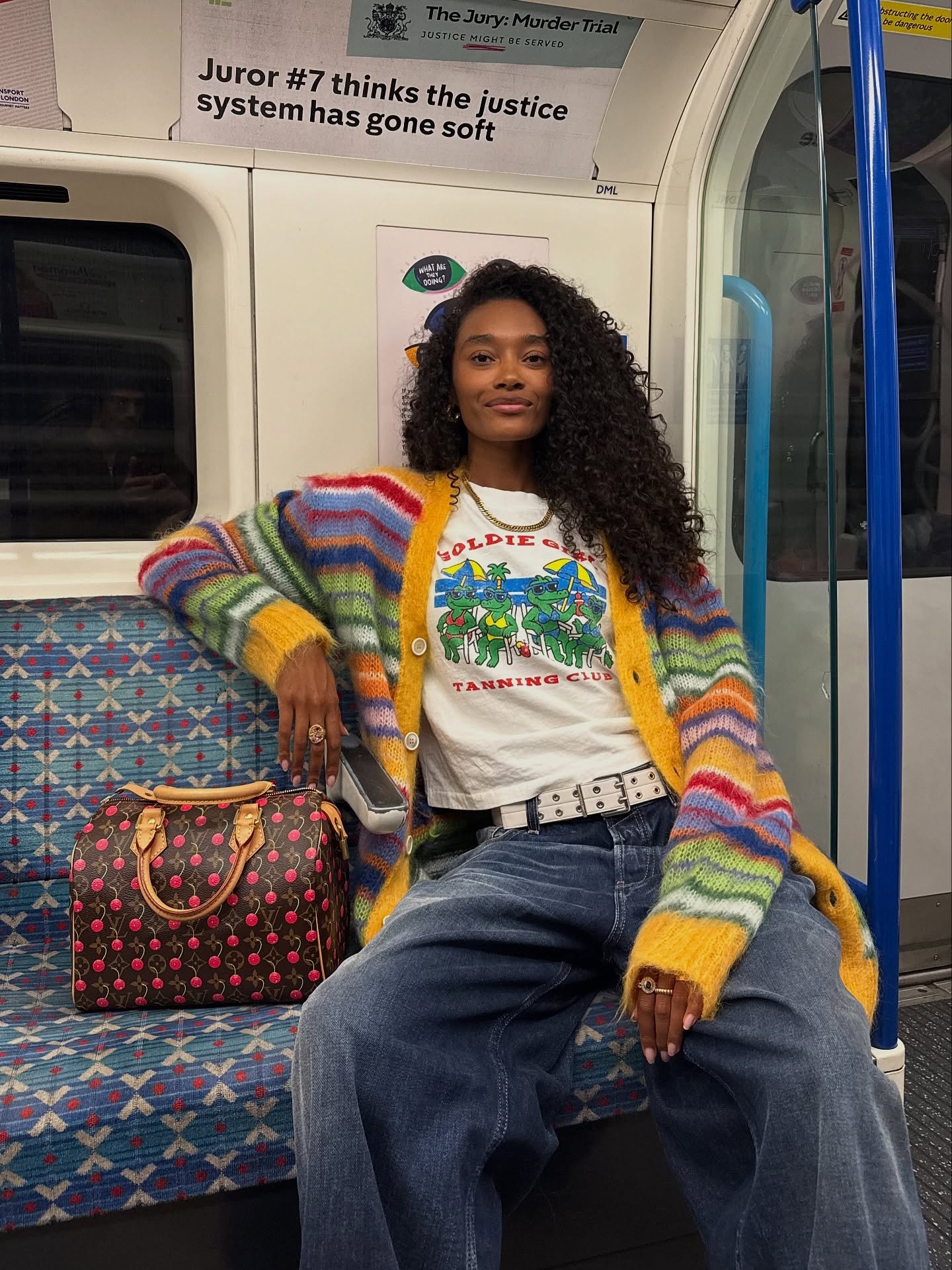 Fashion person Chey Maya wears a winter knitwear trend. She wears a striped jumper. She pairs it with a white graphic tee and baggy jeans. This image was taken from her Instagram recently.
