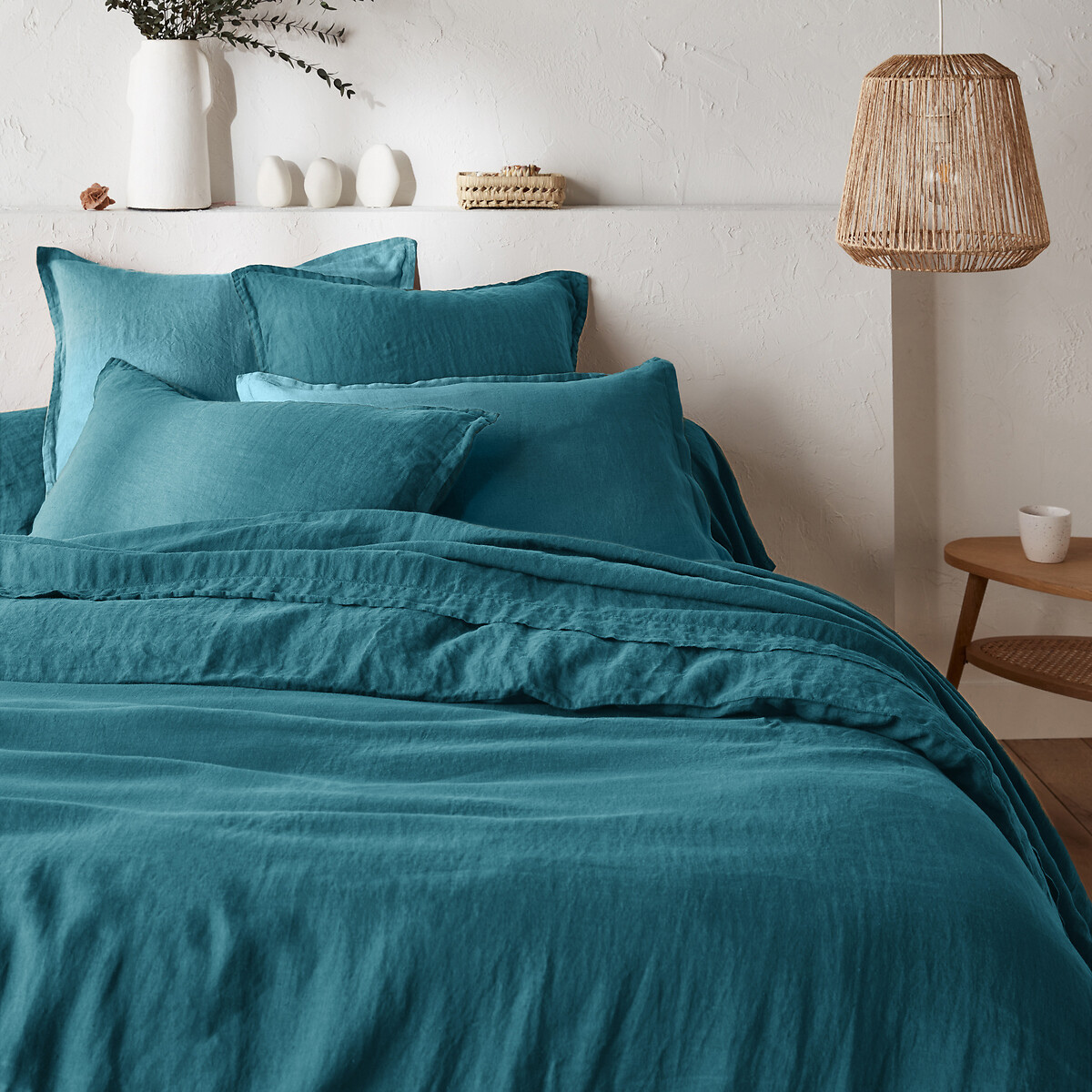 teal blue bedding on a bed in a rustic room