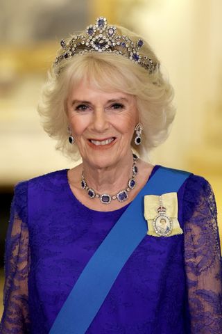 Camilla, Queen Consort is pictured with grey/blonde hair whilst attending the State Banquet in honour of President of South Africa, Cyril Ramaphosa at Buckingham Palace on November 22, 2022 in London, England.