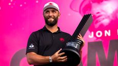 Jon Rahm holding a LIV Golf trophy