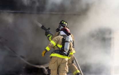 wo firefighters at work putting out a fire