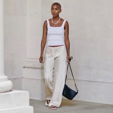 @_marisamartins_ wears cream silk trousers