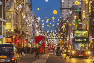 Oxford Street in London, during the evening with Christmas decorations and lights.