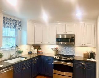 Kitchen with blue lower and white upper cabinets