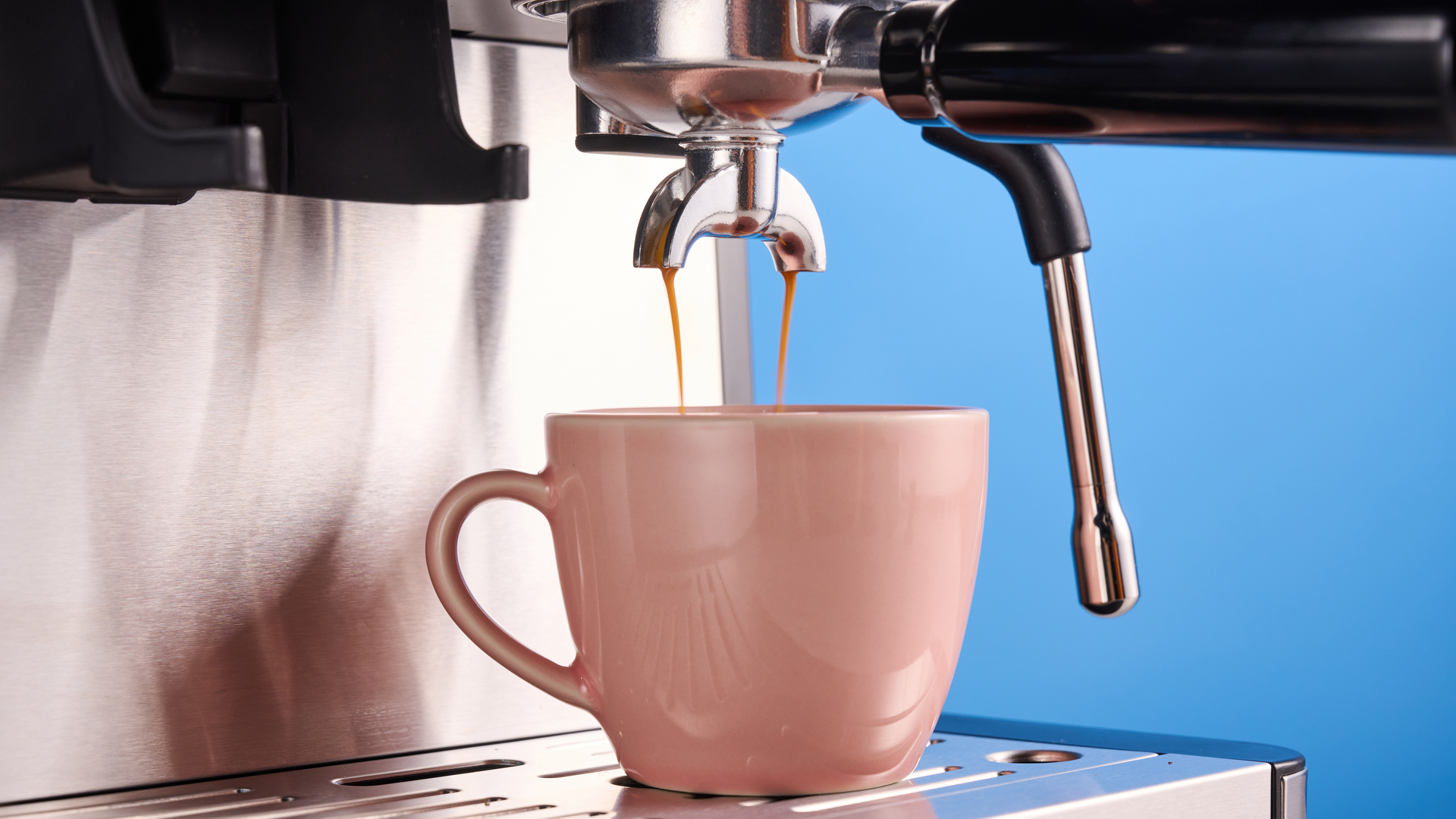 the gevi espresso machine with grinder showing its bean hopper, steam wand, and control screen with a silver dial and drip tray