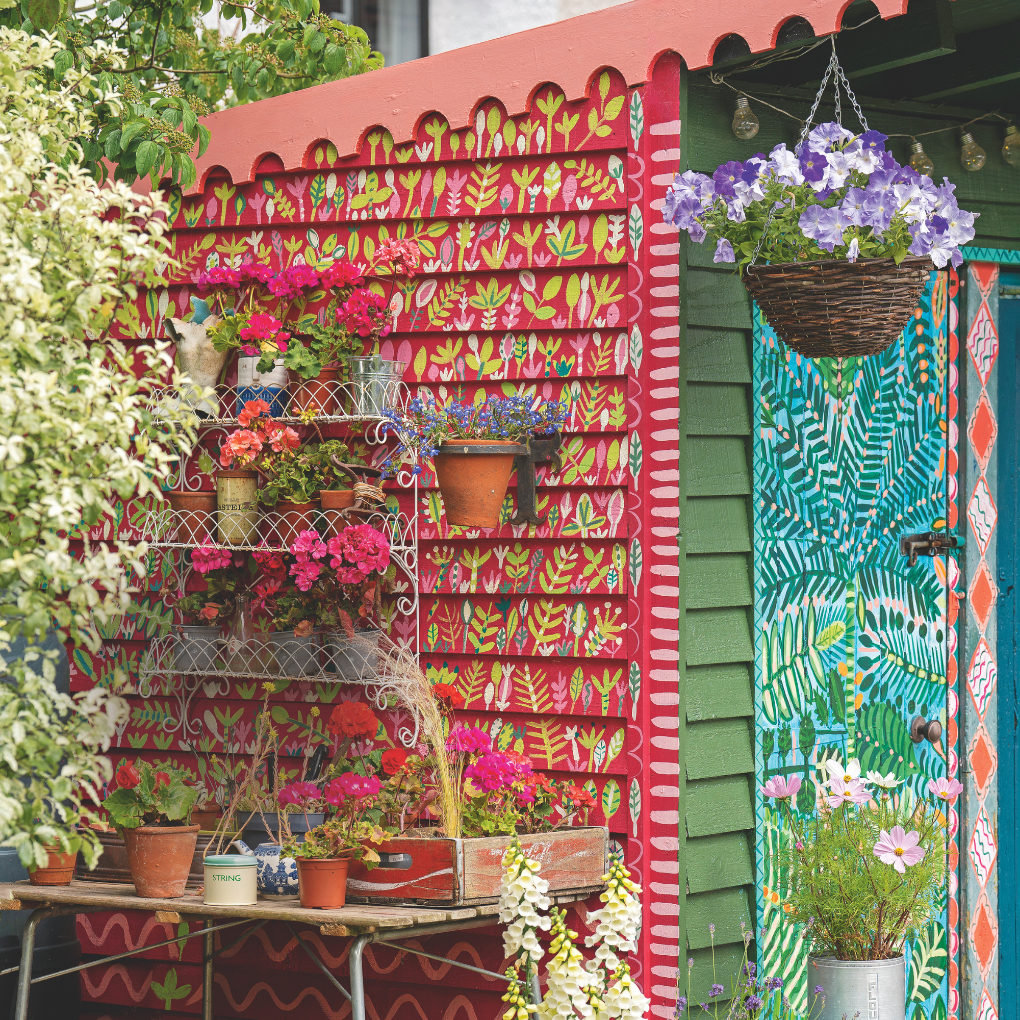 Painted blue and pink shed with intricate floral patterns.