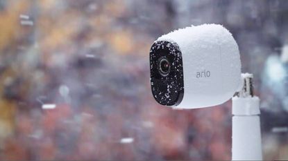 An Arlo outdoor security camera in the snow