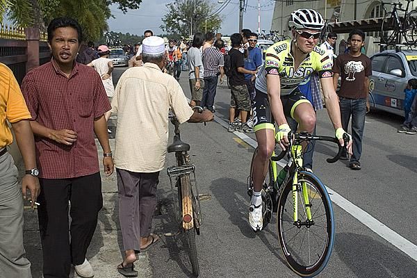 My bikes better than yours: Grabovskyy Dmytro (ISD-Neri) from the Ukraine makes his way to the startline passing a local cycling fan perhaps.
