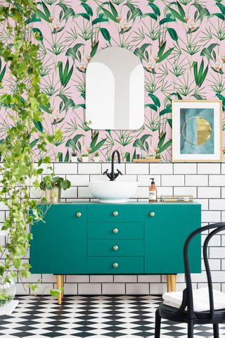 small bathroom with teal vanity unit with printed wallpaper by Mindthegap