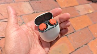 The Google Pixel Buds Pro charging case being held in hand
