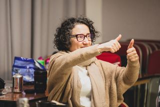 Paula Garfield, founder and theatre director of Deafinitely Theatre, the UK's first deaf-led theatre company, gives a thumbs-up