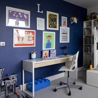 home office with dark blue wall and table and chair