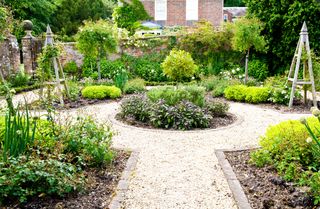 A formal herb or kitchen garden in the grounds of an English country house