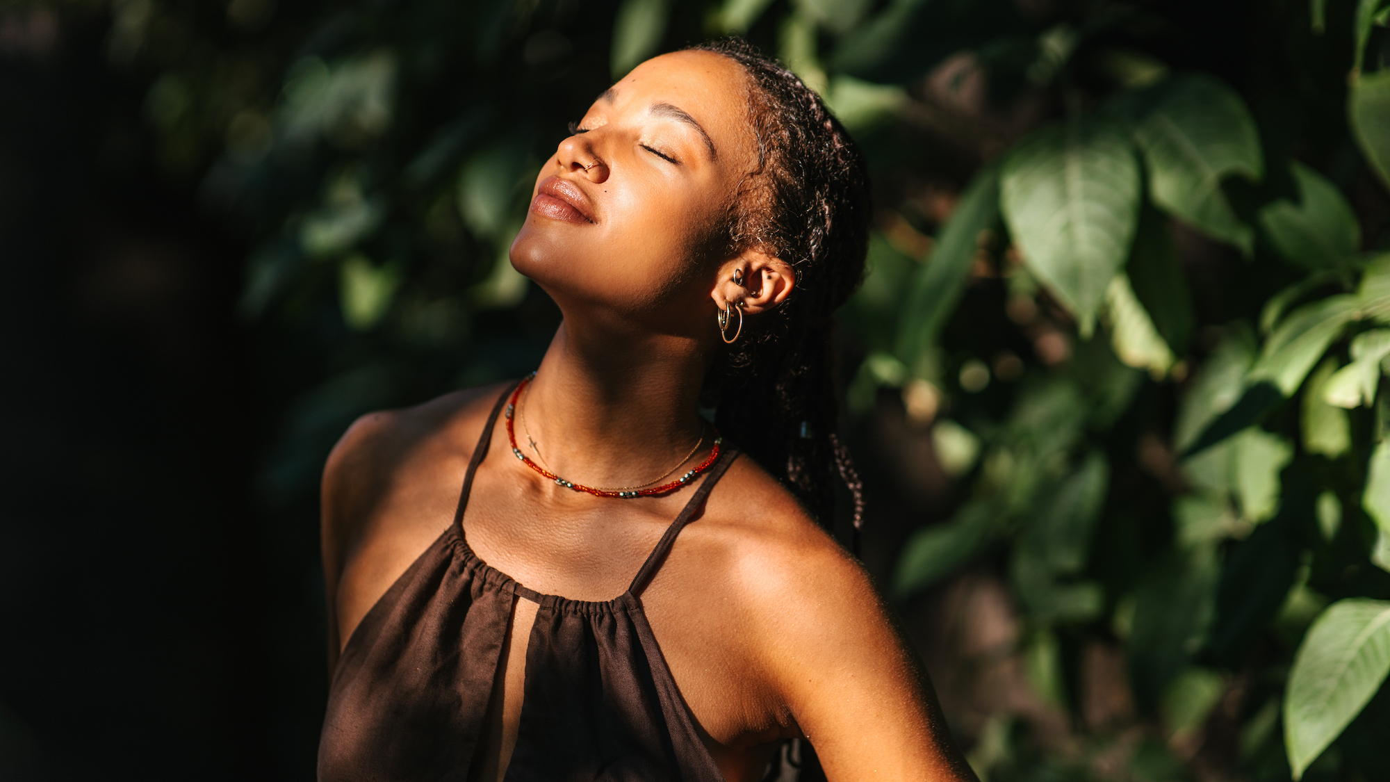 Woman with bright and glowy skin facing towards the sun