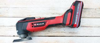 Red Einhell Multitool on whitewashed wood