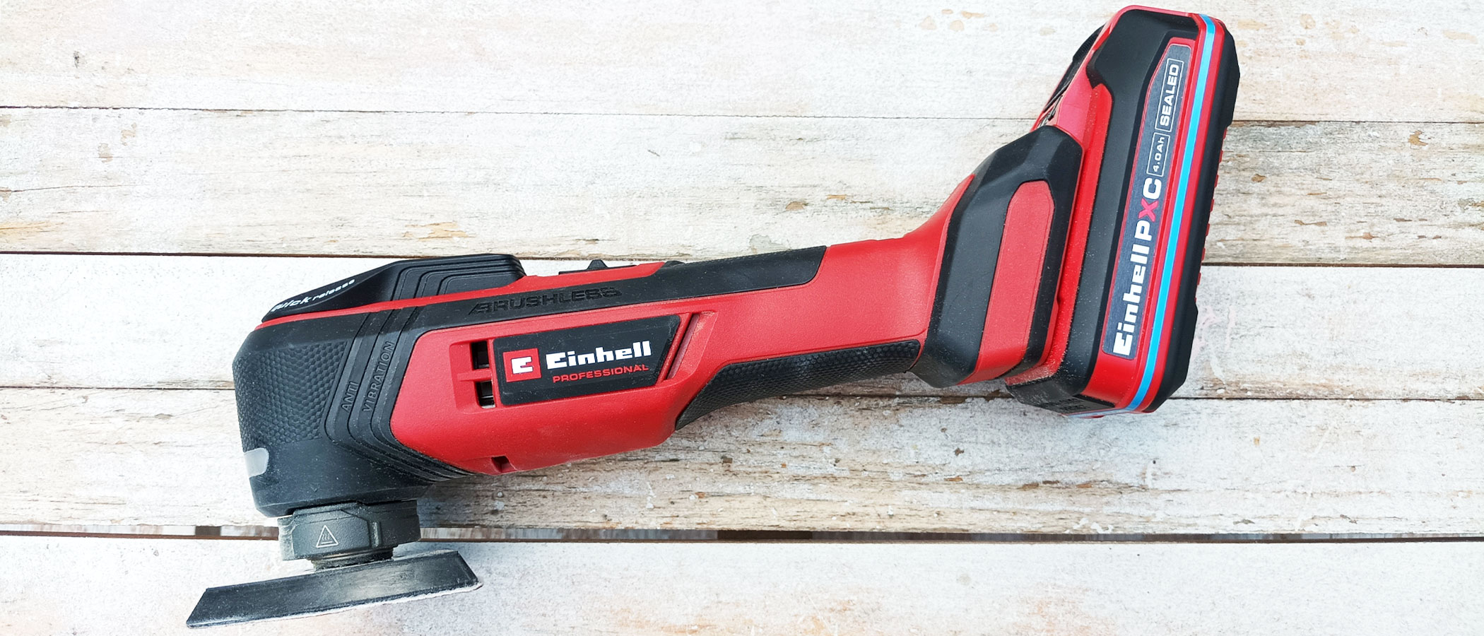Red Einhell Multi tool on whitewashed wood