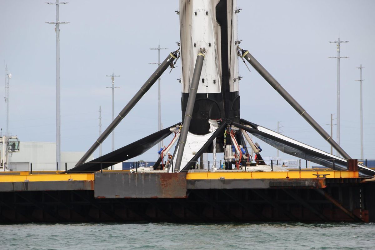 A SpaceX Falcon 9 booster returns to shore with a lean, on Nov. 19, 2020.