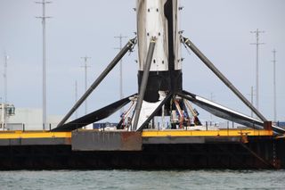 A SpaceX Falcon 9 booster returns to shore with a lean, on Nov. 19, 2020.