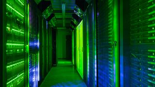 Data center server room lit with green lights