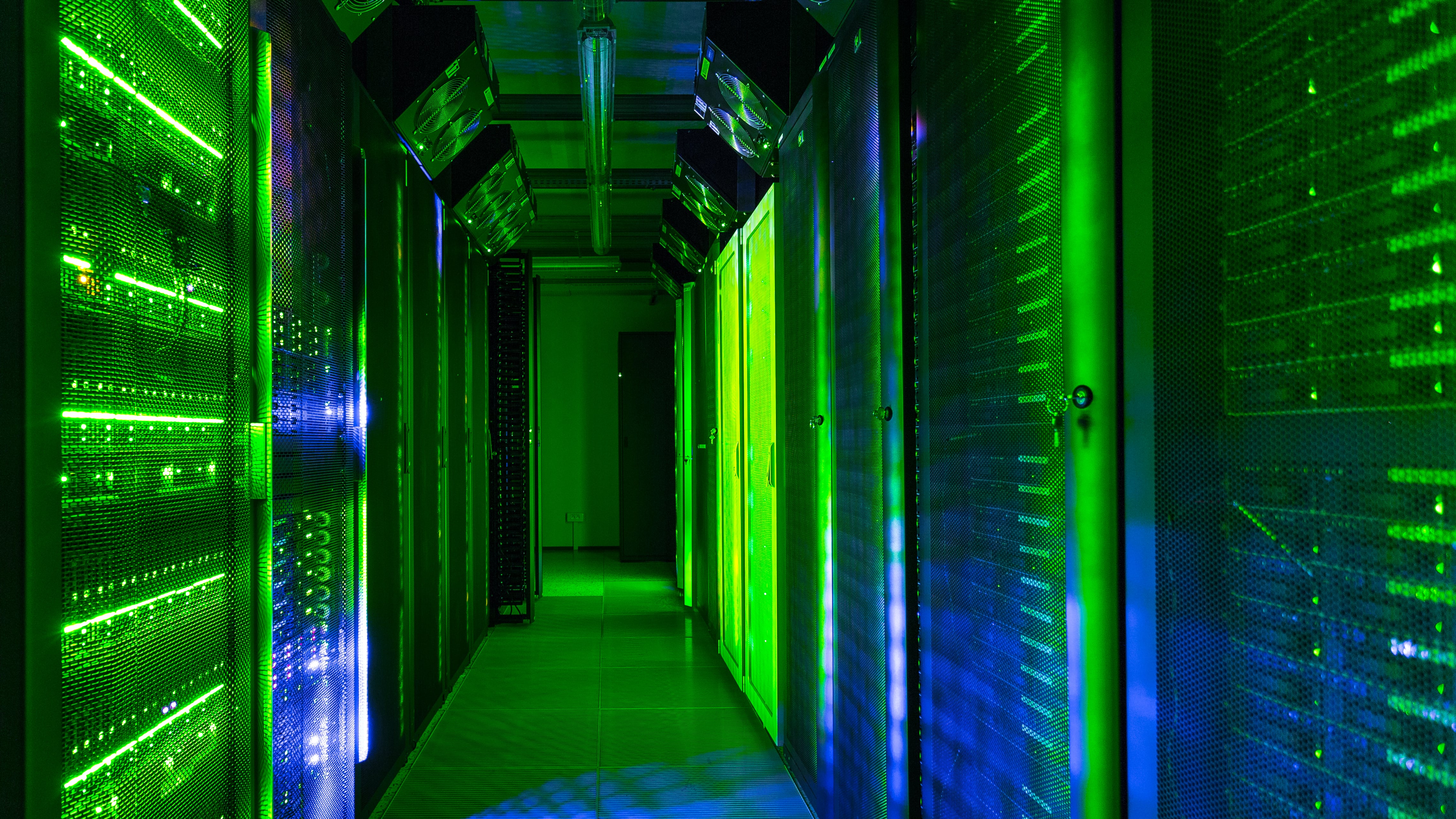 Data center server room lit with green lights