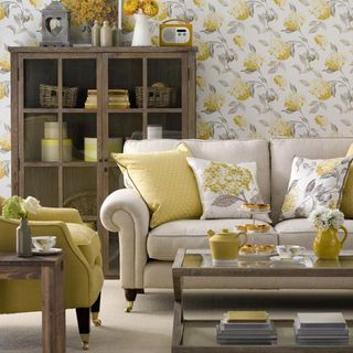 living room with yellow flower wallpaper and armchair