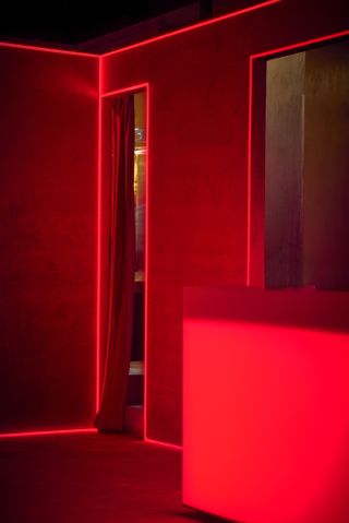 Silencio New York boasts eclectic red and golden interiors drip in neon lights