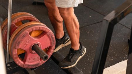 a man doing calf raises in the gym