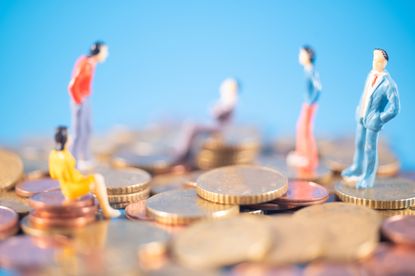 models of people standing on coins