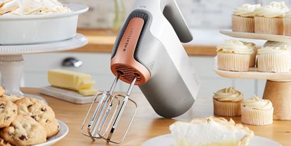 Image of Oster Heatsoft Mixer in lifestyle image being used to make meringue pie and cupcakes