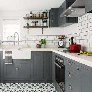 kitchen room with white tiled walls and printed tiled flooring