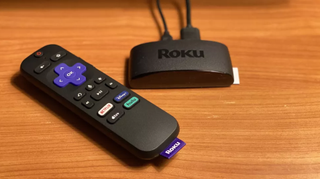 Roku Express 4K+ (2021) pictured on a wooden surface