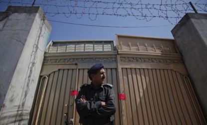 A policeman guards the compound in Pakistan where Osama bin Laden was killed: During the raid, Navy SEALs captured a load of digital data that could hold key intelligence on the inner working