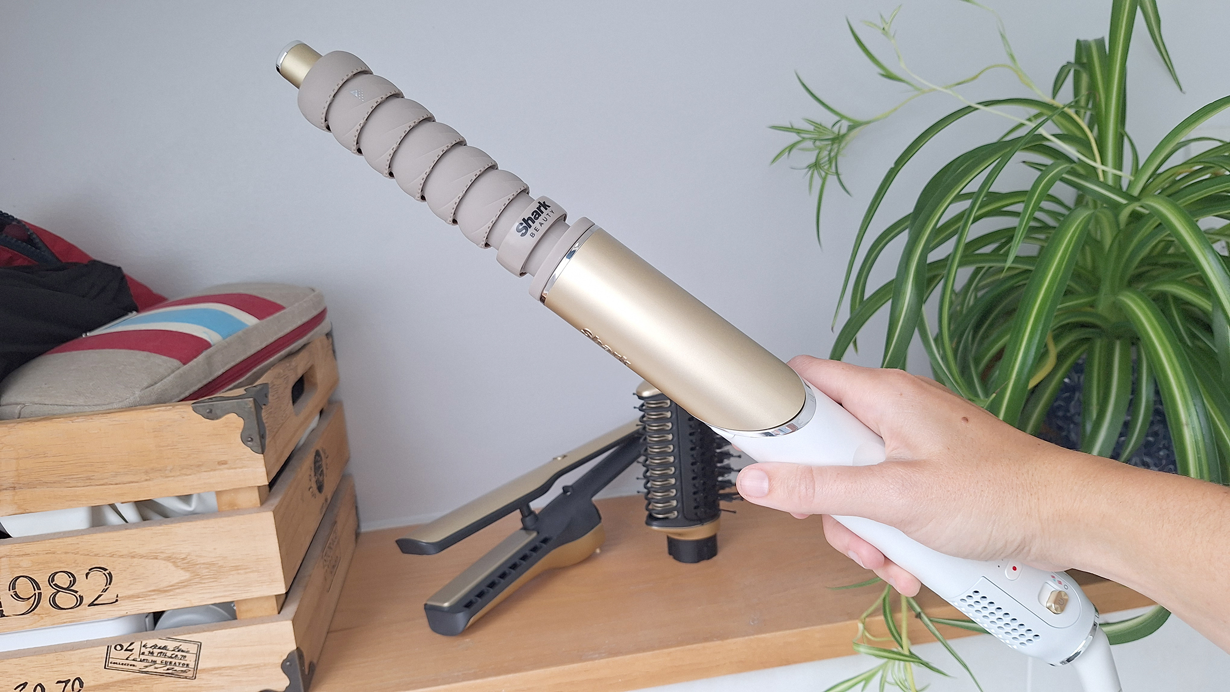 Tester holding Shark Glam Multi-Styler, with curl barrel attached