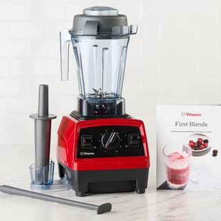 Vitamix Explorian 2.0 Variable Speed Blender against a white wall.