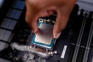 Intel Core i9-14900K being installed into a motherboard CPU socket