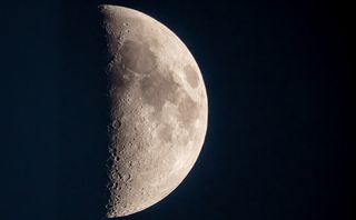 close up view of a half illuminated moon