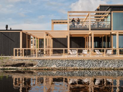 luoto sauna restaurant hero exterior with blue skies and water as example of wellness architecture