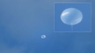 A white balloon against a blue sky