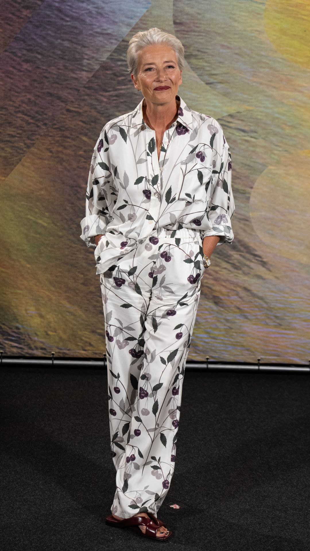 emma thompson wearing a white printed shirt and trouser set