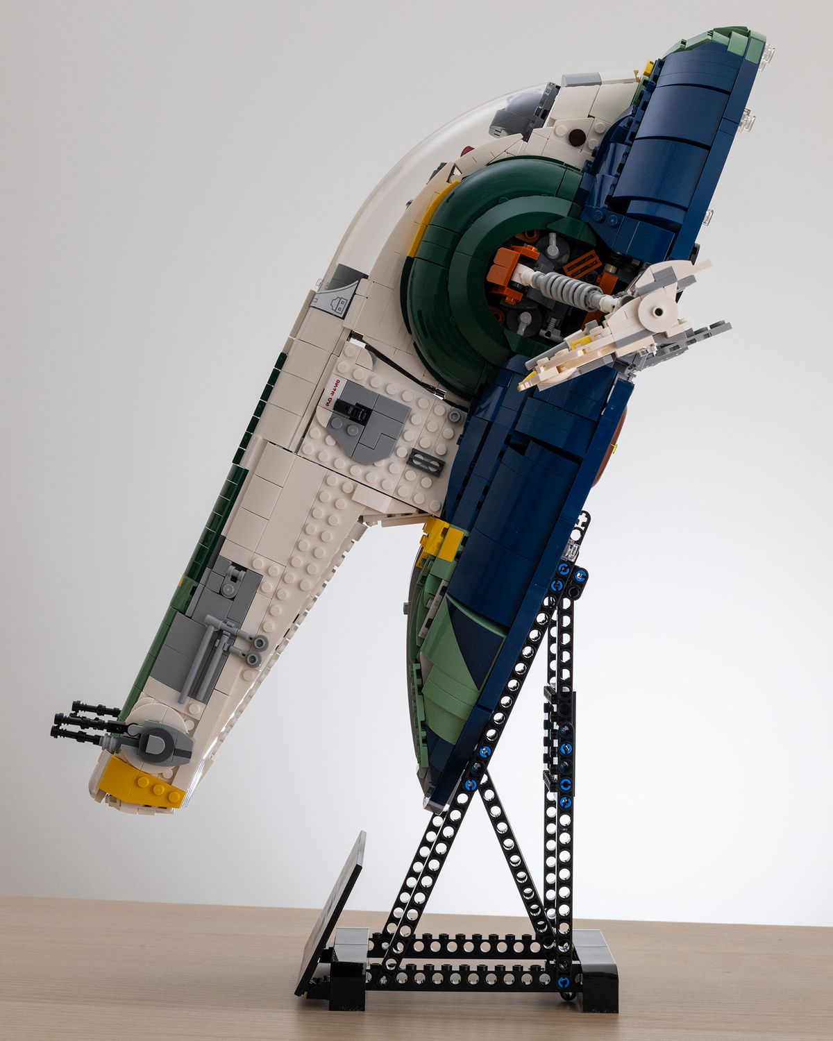 Lego Star Wars UCS Jango Fett&rsquo;s Firespray-Class Starship (75409) on a table with a white background side-on image
