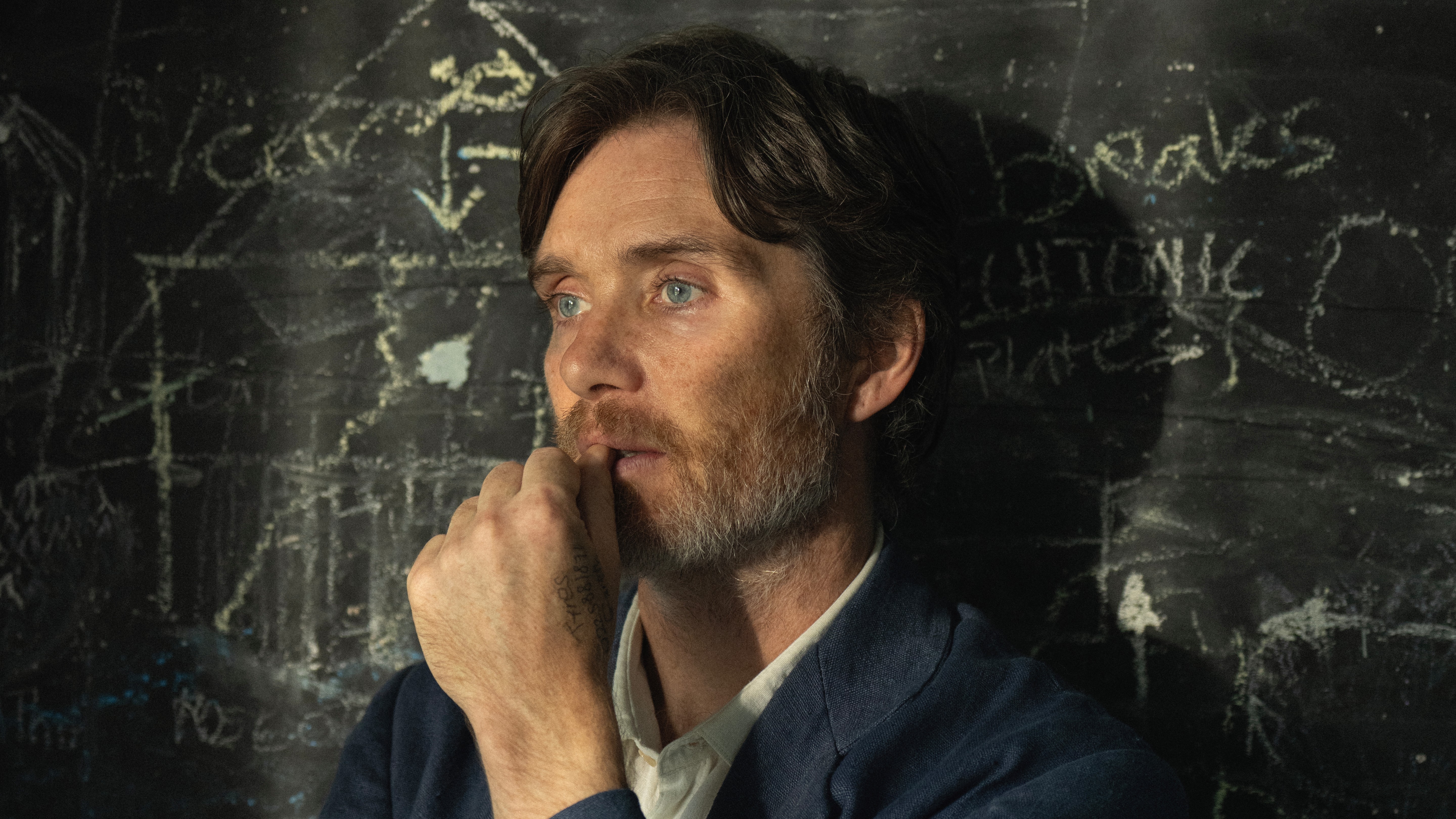 Steve (Cillian Murphy) stands in front of a chalkboard in a promotional still from Netflix's "Steve"