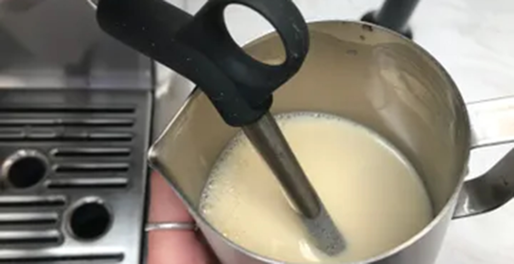 sage The Barista Exoress frothing a jug of oat milk