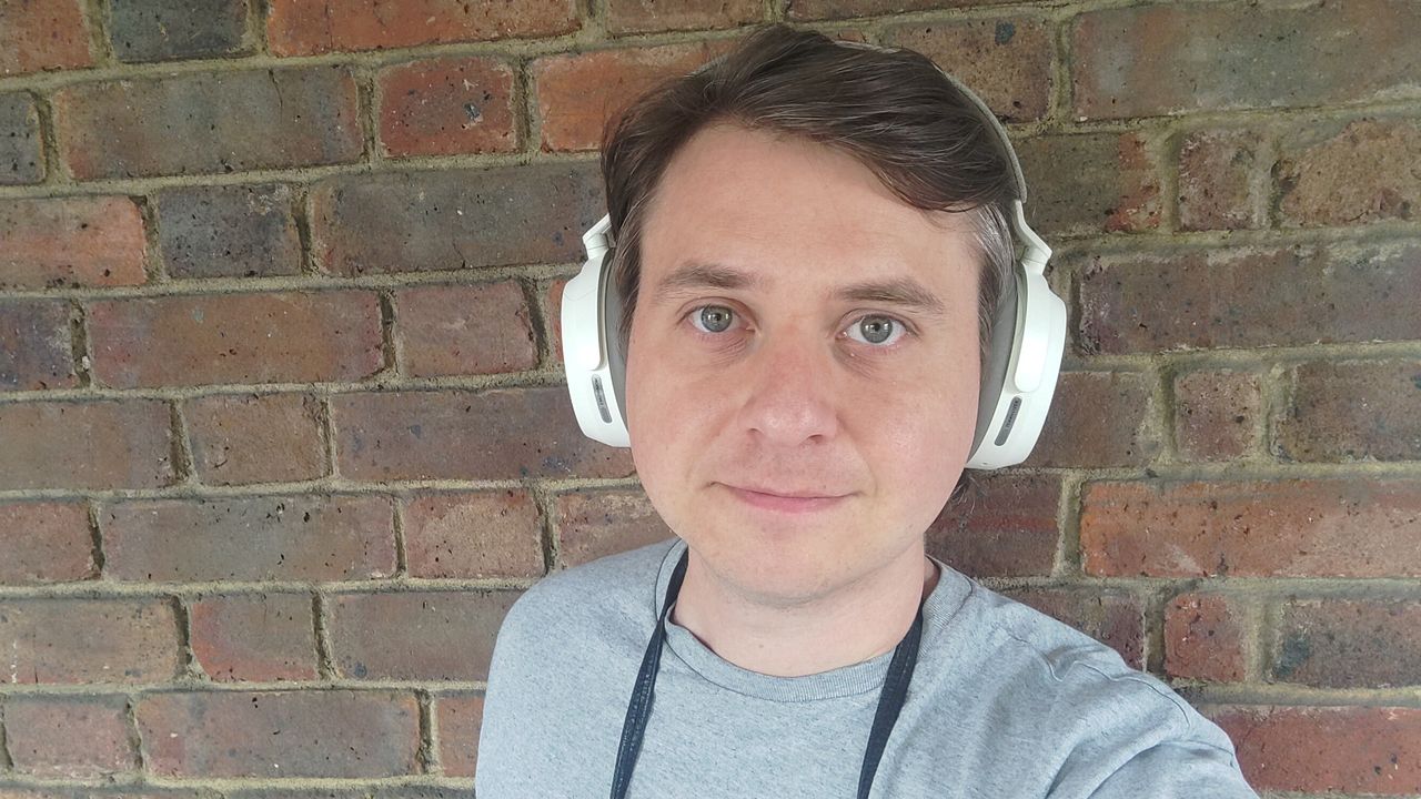 Photograph of man wearing Sennheiser Momentum 5 headphones