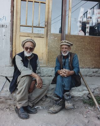 Two men sitting on doorstep